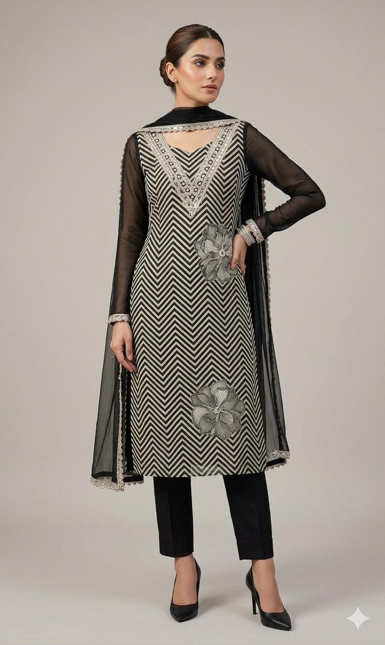 The shirt (kameez) is adorned with a continuous black and cream chevron (zigzag) print, creating a dynamic visual texture that elongates the frame.