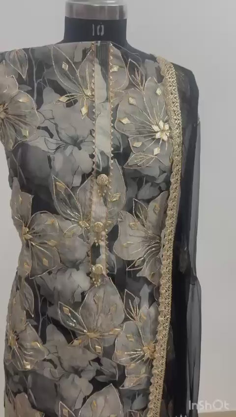 Crafted from high-quality georgette, the shirt features a large-scale, ethereal floral print in shades of charcoal, misty grey, and black